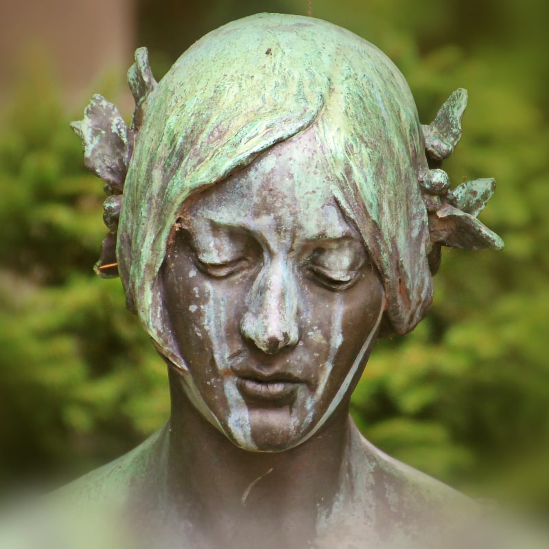 copper statue of a woman's face